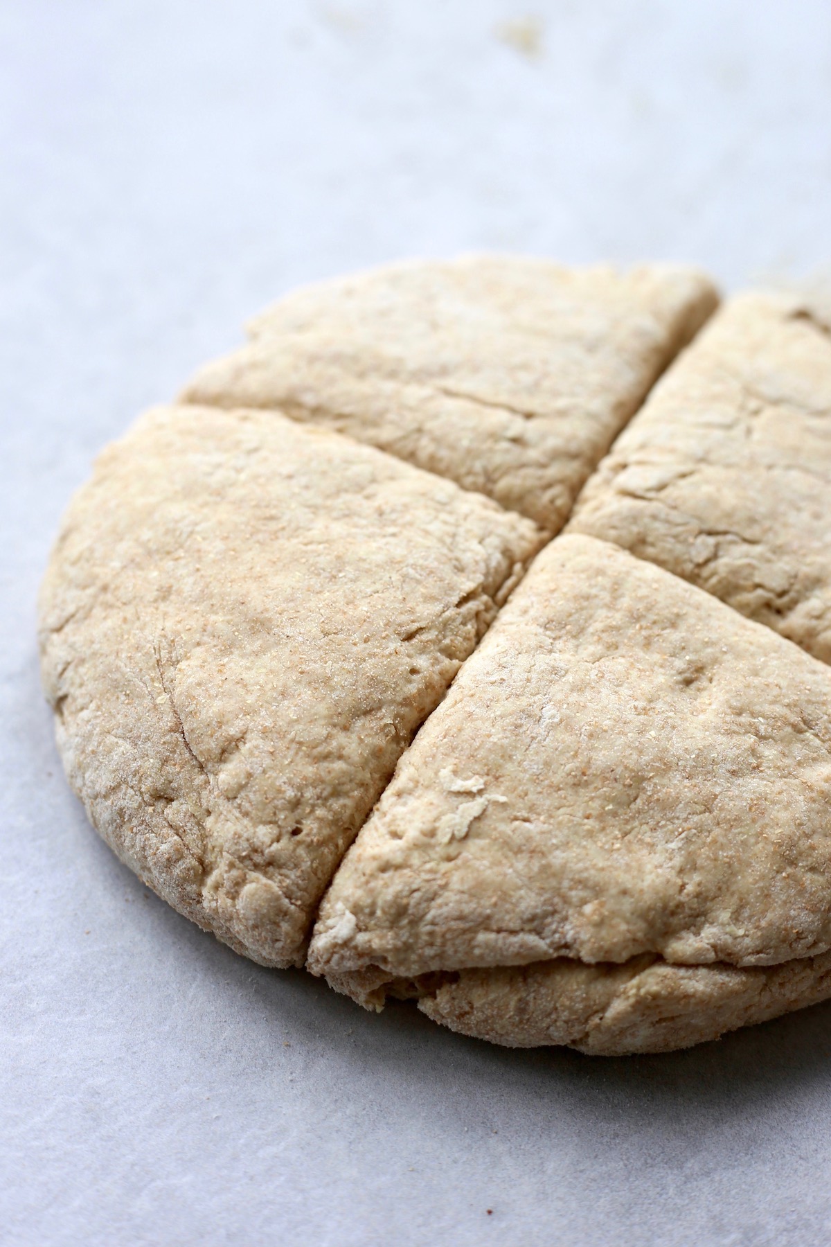 Soda bread dough cut into fourths to make soda farls