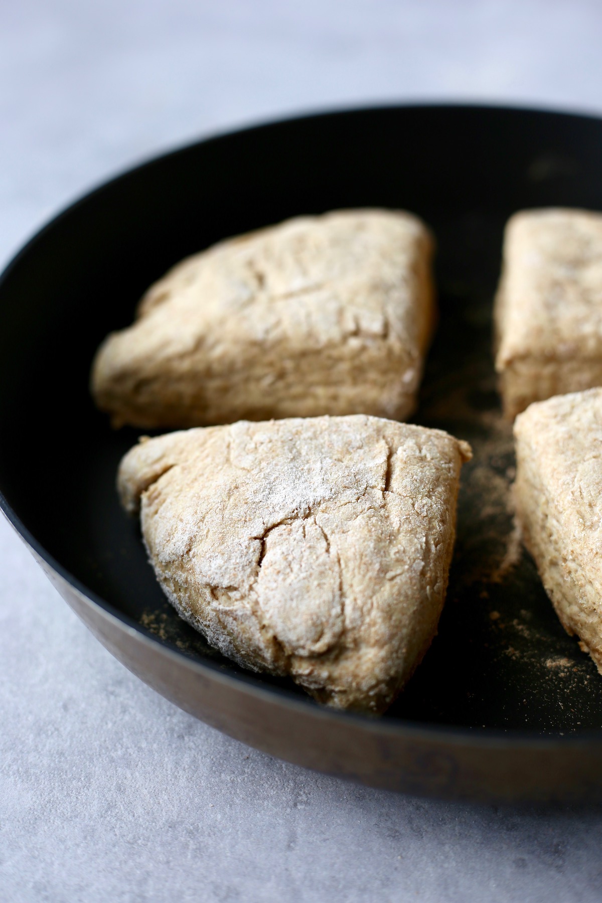 soda bread being cooked on a skilled to make soda farls