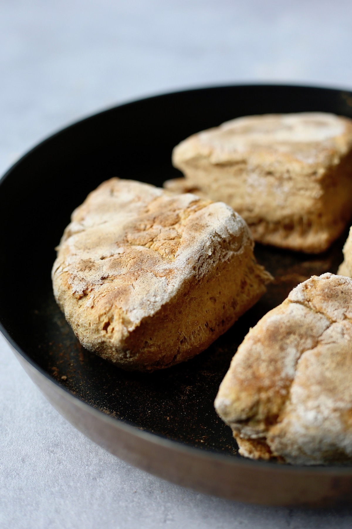 thick vegan Irish soda farls or soda bread cooking on a skillet