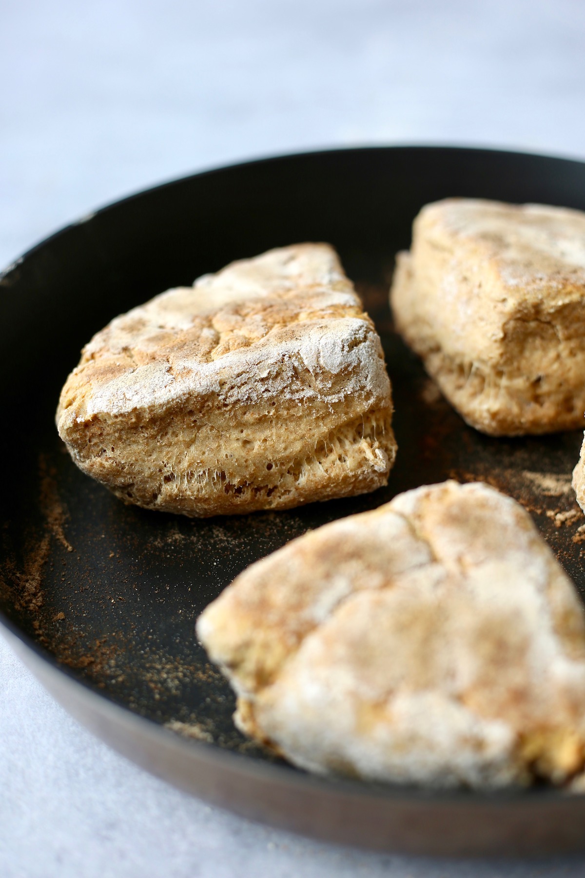soda farls being cooked on a skilled until golden brown on the outside