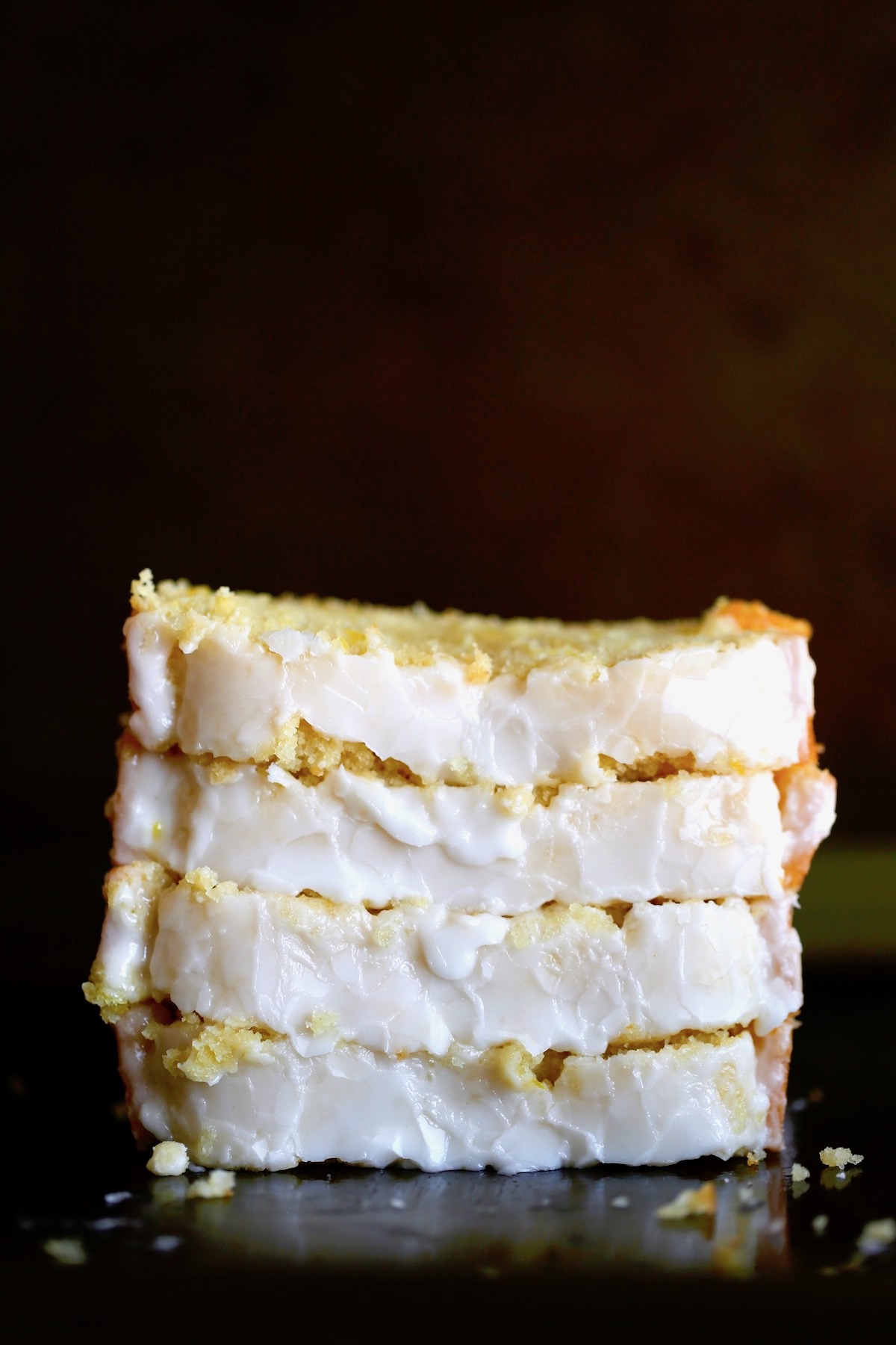 thick slices of vegan lemon cake stacked on each other