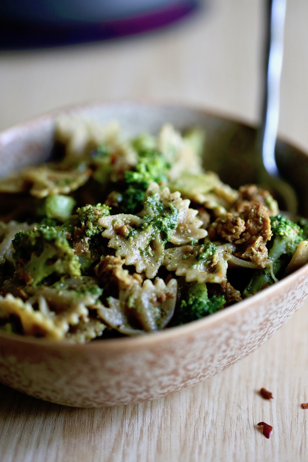 vegan sausage pesto pasta with broccoli piled high in a bowl