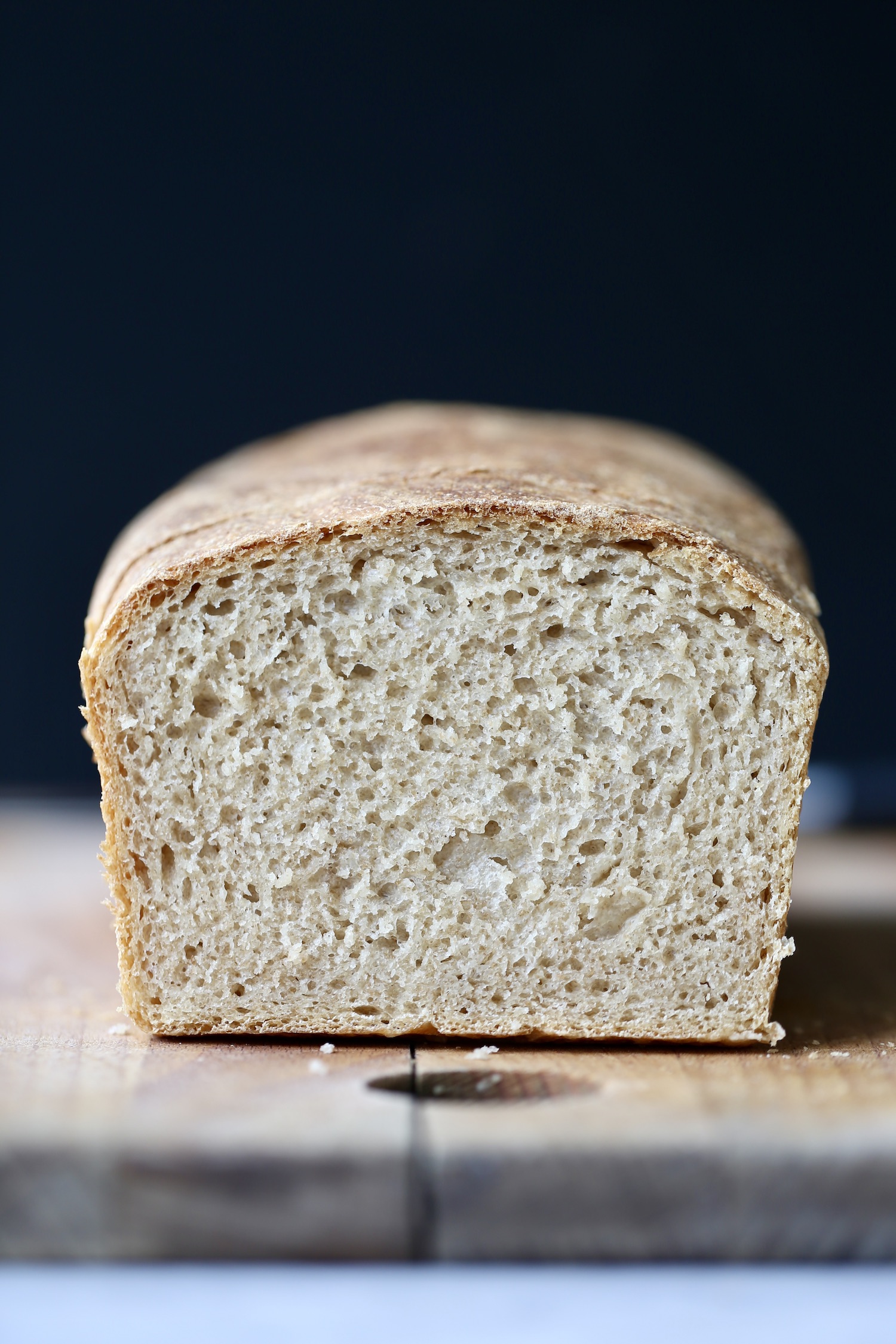 An inside shot of vegan sourdough bread on a wooden cutting board. 