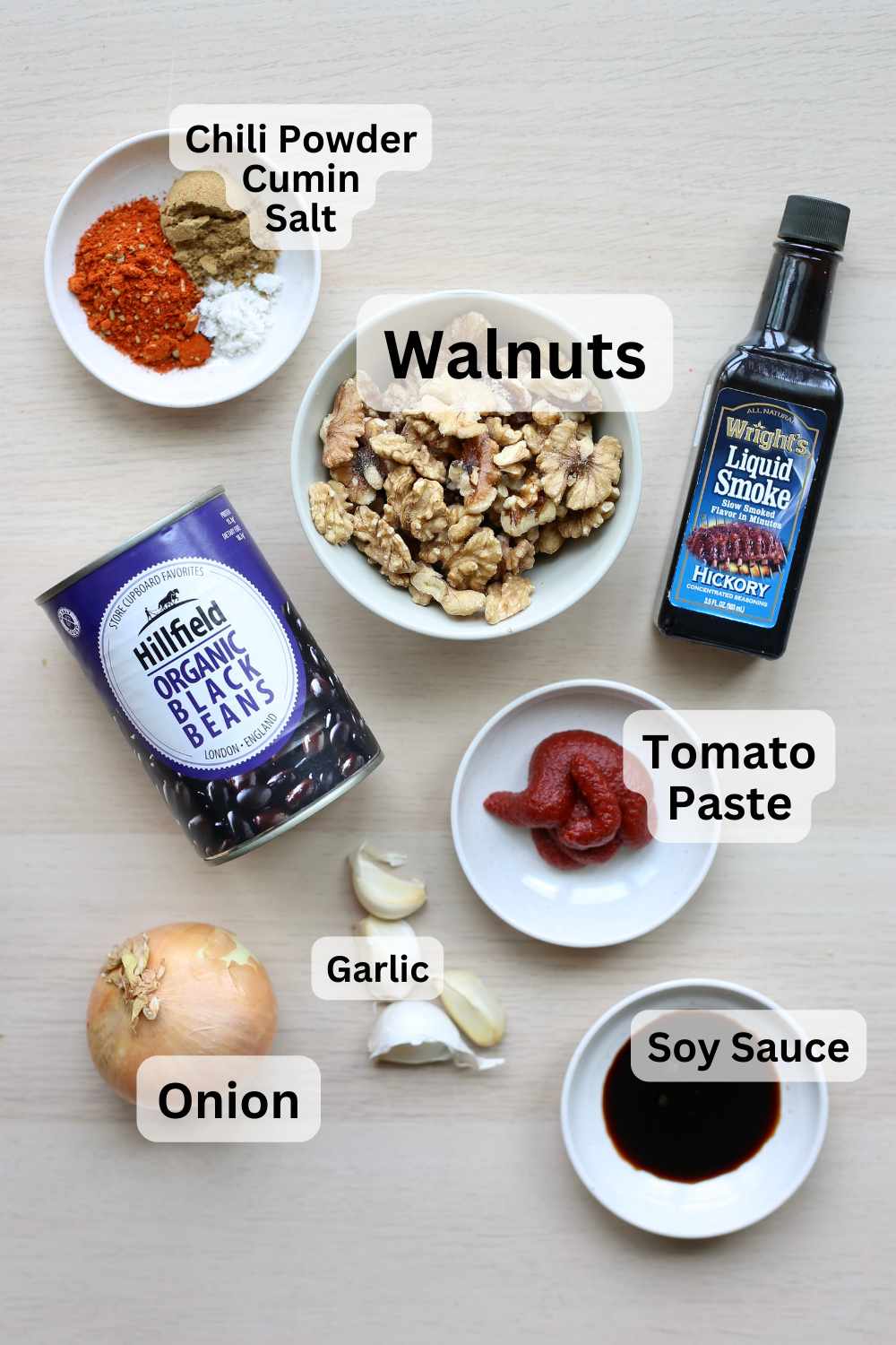 All of the ingredients for walnut meat measured out into bowls and laid out on a table. 