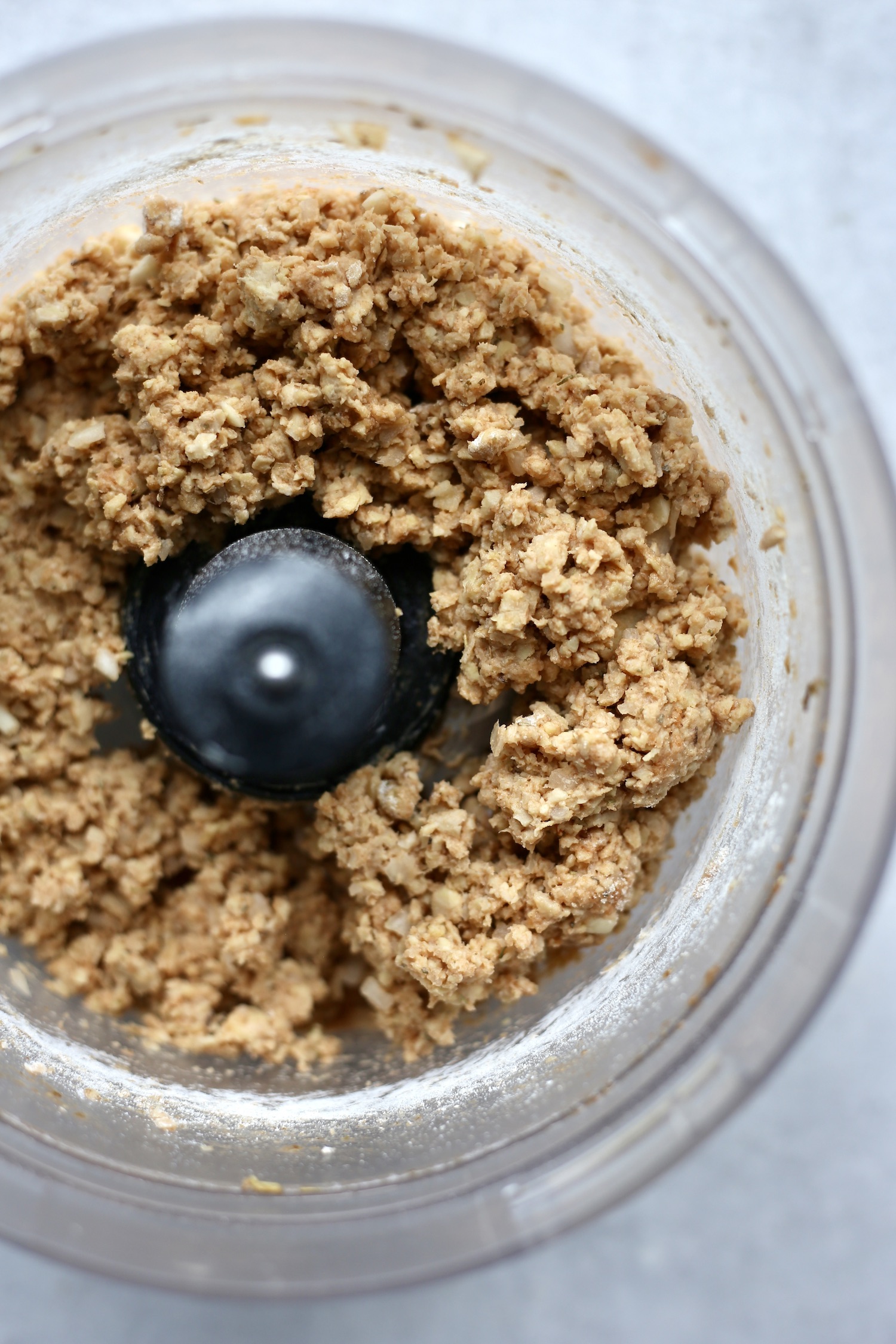 tempeh meatball mixture in a food processor ready to be rolled into meatballs